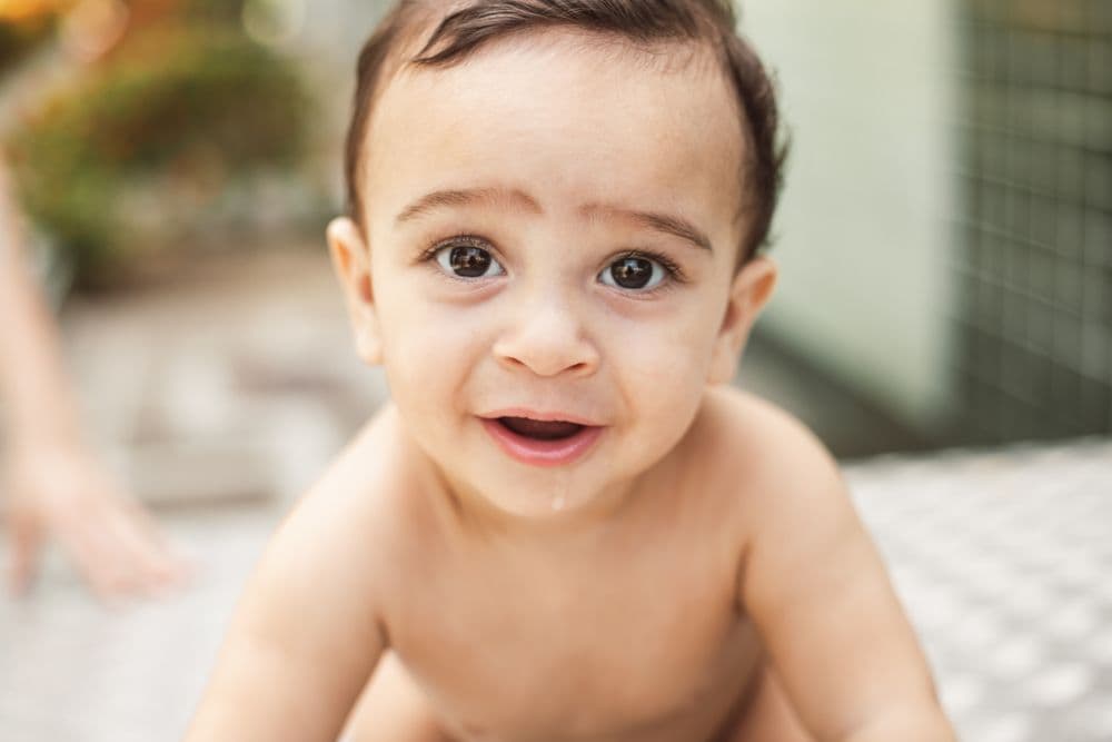 A smiling baby looking toward the camera