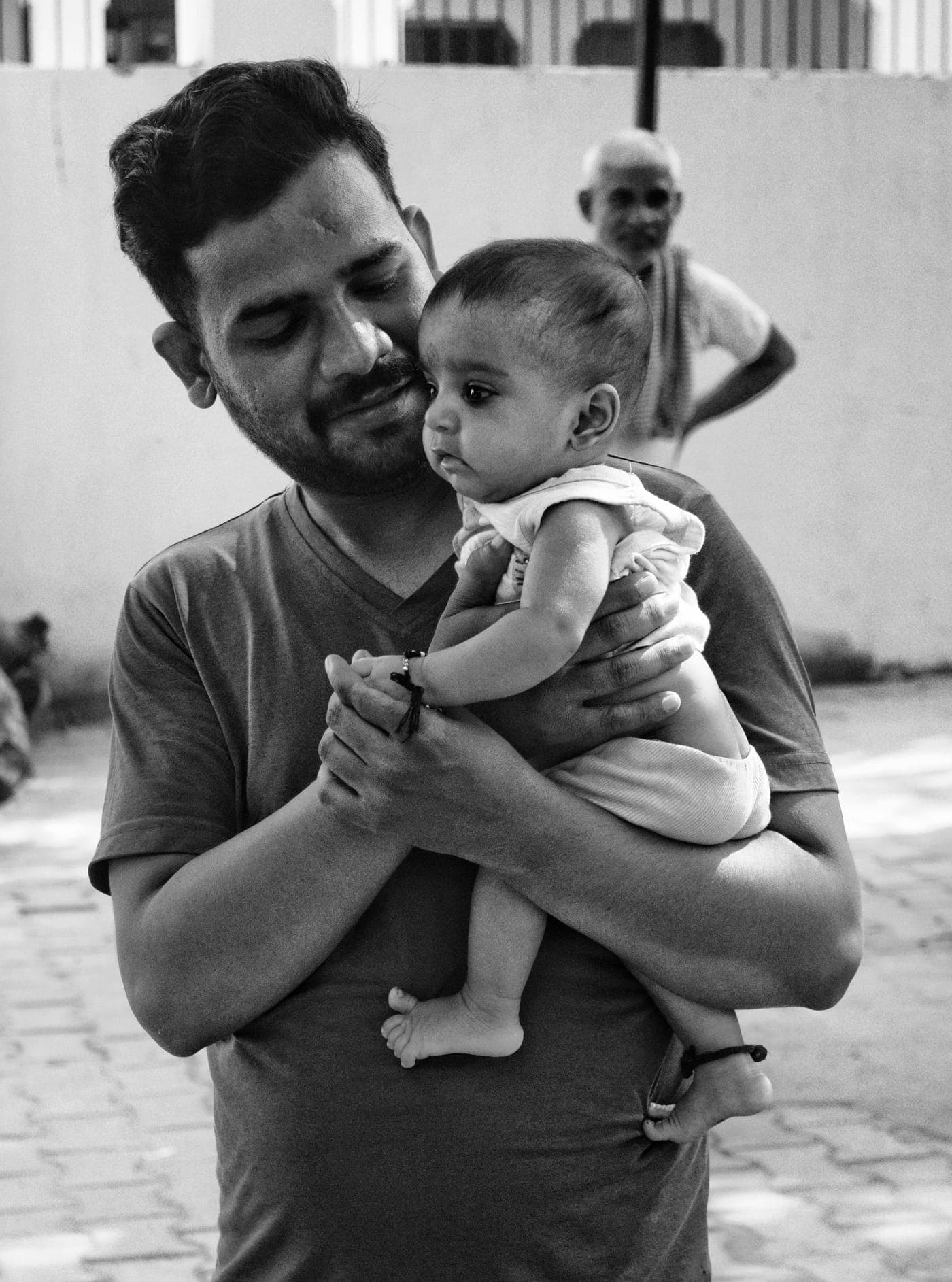 A parent tenderly cradling their newborn