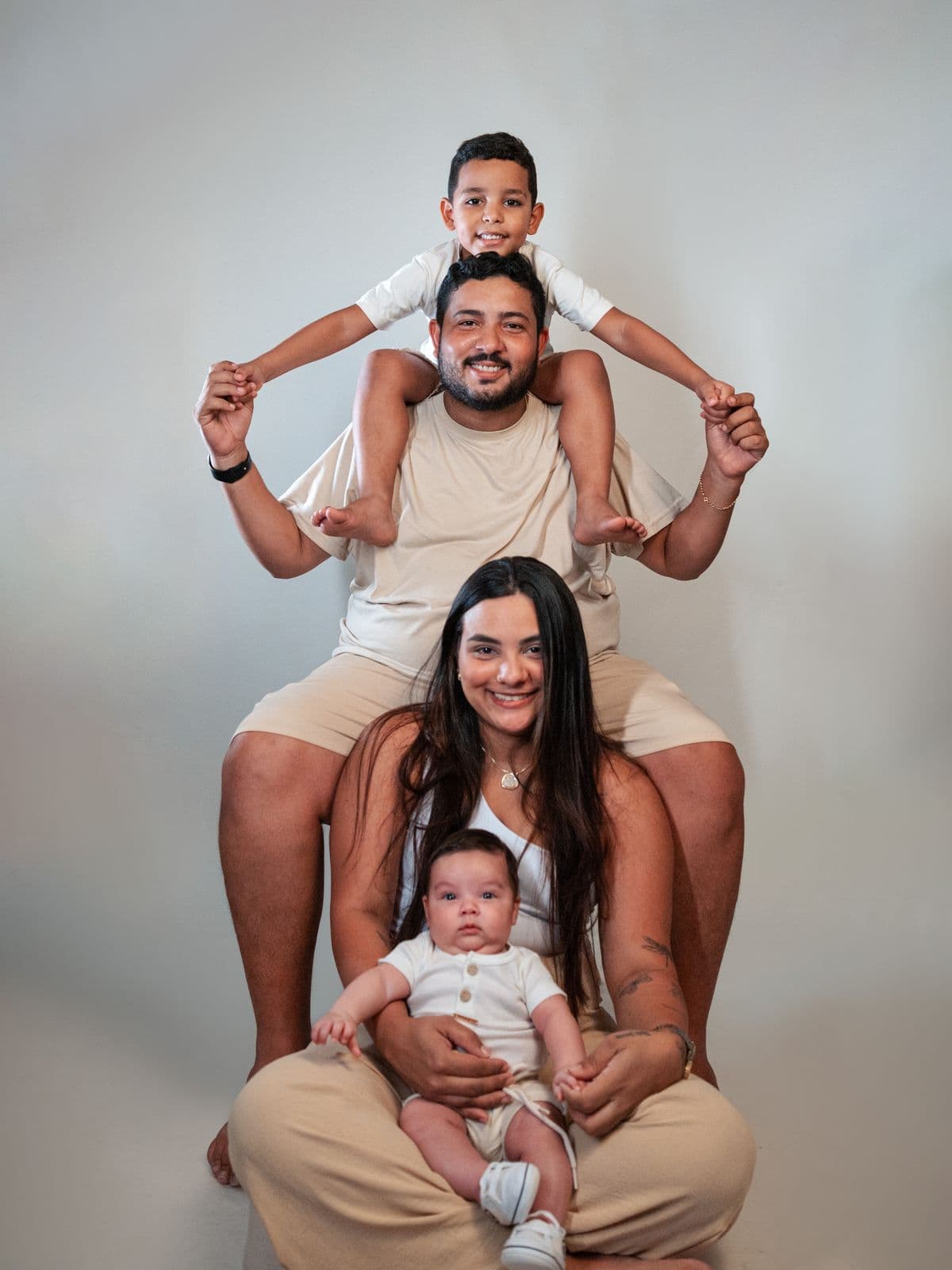 Parents with their two young children in a warm family portrait